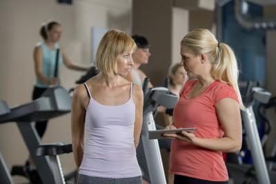 éducation à la santé conseillant femme en salle de gym