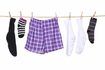Hommes's underwear and socks hanging from clothes line.
